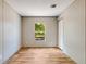 The bedroom has a light wall with a closet and a window with great natural light and wood-look floors at 254 Nelson Farm Ln, Cross, SC 29436