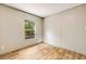 Inviting bedroom with wood-look flooring, light walls, and a window offering a view of the surrounding trees at 254 Nelson Farm Ln, Cross, SC 29436