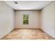 Neat bedroom featuring wood-look floors, neutral walls, and a window with an outside view at 254 Nelson Farm Ln, Cross, SC 29436