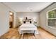 Comfortable bedroom with an ensuite bathroom featuring wood-look flooring, natural light and neutral tones at 254 Nelson Farm Ln, Cross, SC 29436