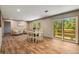 Dining room features an six seat dining table and sliding door access to deck with views of the surrounding yard at 254 Nelson Farm Ln, Cross, SC 29436