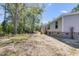 This home features light gray siding, a functional deck, and is nestled among mature trees at 254 Nelson Farm Ln, Cross, SC 29436