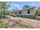 Exterior view of the home's light gray siding, wooden deck, and natural surroundings at 254 Nelson Farm Ln, Cross, SC 29436