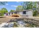 A light gray home with a matching outbuilding and a wooden porch, set on a spacious lot with mature trees at 254 Nelson Farm Ln, Cross, SC 29436