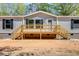 Inviting front porch with light-colored wood, offering a welcoming entrance to the home at 254 Nelson Farm Ln, Cross, SC 29436