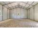 Bright, spacious two-car garage interior featuring gravel floor, white walls, and natural light at 254 Nelson Farm Ln, Cross, SC 29436