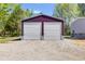 Large two car detached garage with two roll-up doors and parking outside on a gravel drive at 254 Nelson Farm Ln, Cross, SC 29436