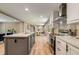 Bright kitchen features a center island with bar seating, stainless steel appliances, and white cabinetry at 254 Nelson Farm Ln, Cross, SC 29436