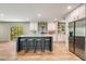 Bright kitchen features a center island with bar seating, stainless steel appliances, and white cabinetry at 254 Nelson Farm Ln, Cross, SC 29436