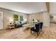 Comfortable living room with large windows, light wood floors, and stylish accent wall at 254 Nelson Farm Ln, Cross, SC 29436
