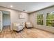 Cozy living room area with a pair of chairs with decorative pillows and natural light from a pair of windows at 254 Nelson Farm Ln, Cross, SC 29436
