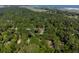 An aerial view of a property surrounded by lush trees, offering privacy and seclusion with water views in the distance at 2766 Old Oak Walk, Seabrook Island, SC 29455