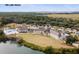 A scenic aerial shot showcases a pool adjacent to an expansive recreational facility near a tranquil lake at 2766 Old Oak Walk, Seabrook Island, SC 29455