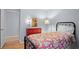Bedroom with hardwood floors, bright paint, black metal bed frame, and floral-patterned bedding at 2766 Old Oak Walk, Seabrook Island, SC 29455