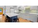 Bright kitchen features a center island, white cabinets, stainless appliances, and stylish mosaic backsplash at 2766 Old Oak Walk, Seabrook Island, SC 29455