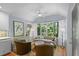 Inviting living room with large windows, hardwood floors, neutral tones, and comfortable seating arrangement at 2766 Old Oak Walk, Seabrook Island, SC 29455