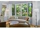 Bright living room featuring a large window with backyard views, hardwood floors, and tasteful decor at 2766 Old Oak Walk, Seabrook Island, SC 29455