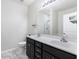 Well-lit bathroom featuring double sinks, dark wood cabinets, and a shower for added convenience at 278 Decatur Dr, Summerville, SC 29483