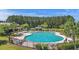 Community pool area with lush surroundings, lounge chairs, and shady area perfect for relaxation at 278 Decatur Dr, Summerville, SC 29483