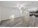 Expansive living room with wood-look flooring, a ceiling fan, and an open layout to the kitchen at 278 Decatur Dr, Summerville, SC 29483