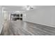 Open-concept living room with wood-look floors and a view into the kitchen with stainless appliances at 278 Decatur Dr, Summerville, SC 29483