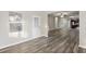 Bright living area with wood-look flooring, a ceiling fan, and views of the front door and kitchen at 278 Decatur Dr, Summerville, SC 29483