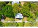 Aerial view of a charming house surrounded by lush greenery and trees at 29 Morrison Ave, McClellanville, SC 29458