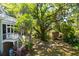 Expansive yard with lush trees, shed, and plenty of shade for relaxing outdoor activities at 29 Morrison Ave, McClellanville, SC 29458