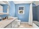 Light blue bathroom features a blue mosaic tile shower and white marble sink at 29 Morrison Ave, McClellanville, SC 29458
