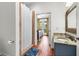 Well-lit bathroom, hardwood floors, tiled shower, and vanity, offering functionality and style at 29 Morrison Ave, McClellanville, SC 29458