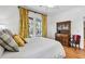 Comfortable bedroom with a ceiling fan, natural light, hardwood floors, and stylish furnishings at 29 Morrison Ave, McClellanville, SC 29458