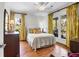 Light-filled bedroom with hardwood flooring, large windows, ceiling fan, and stylish furnishings at 29 Morrison Ave, McClellanville, SC 29458