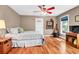 Comfortable bedroom featuring hardwood floors, natural light, and a ceiling fan at 29 Morrison Ave, McClellanville, SC 29458