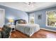 Inviting bedroom with hardwood floors, two windows, and ceiling fan at 29 Morrison Ave, McClellanville, SC 29458