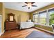 Bedroom with hardwood floors, ceiling fan and large windows for plentiful natural light at 29 Morrison Ave, McClellanville, SC 29458