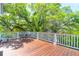 Wooden deck features table and chairs nestled among lush green trees at 29 Morrison Ave, McClellanville, SC 29458