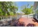 Wooden deck features table and chairs with views of nature at 29 Morrison Ave, McClellanville, SC 29458