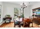 Inviting dining room with natural light, hardwood floors, chandelier and attractive wood table at 29 Morrison Ave, McClellanville, SC 29458