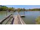 Scenic wooden dock leading to a calm river, complete with boat docks and surrounding marshland at 29 Morrison Ave, McClellanville, SC 29458