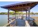 Picturesque dock featuring a covered gazebo with a swing and scenic waterfront views and boat docks at 29 Morrison Ave, McClellanville, SC 29458