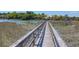 Picturesque wooden dock extending over calm waters, surrounded by marsh grass and waterfront homes at 29 Morrison Ave, McClellanville, SC 29458
