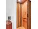 Wood paneled residential elevator featuring a safety bar and buttons for easy access between floors at 29 Morrison Ave, McClellanville, SC 29458