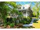 Charming two-story home with a welcoming front porch, landscaped yard, and stairway at 29 Morrison Ave, McClellanville, SC 29458