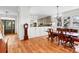 Bright kitchen and dining area featuring hardwood floors, a dining table, and stainless steel appliances at 29 Morrison Ave, McClellanville, SC 29458