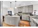 Modern kitchen with a center island, granite countertops, stainless steel appliances, and hardwood floors at 29 Morrison Ave, McClellanville, SC 29458