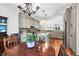 Kitchen with hardwood floors, central island, stainless appliances, and ample natural light from nearby windows at 29 Morrison Ave, McClellanville, SC 29458