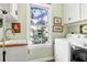 Convenient laundry room with ample natural light and white cabinetry, complete with modern appliances at 29 Morrison Ave, McClellanville, SC 29458