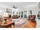 Open living room with hardwood floors, multiple windows, a fireplace, and access to the outdoor deck at 29 Morrison Ave, McClellanville, SC 29458