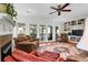 Cozy living room showcasing a fireplace, plush seating, built-in shelving, and outdoor access to the porch at 29 Morrison Ave, McClellanville, SC 29458
