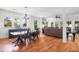 Bright living room with fireplace, hardwood floors, and views of the surrounding trees through plentiful windows at 29 Morrison Ave, McClellanville, SC 29458